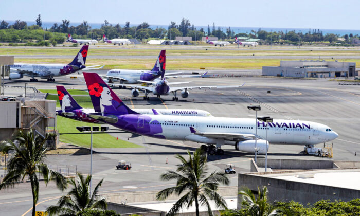 Hawaiian Airlines airplanes sit idle on the runway at the Daniel K. Inouye International Airport in Honolulu, Hawaii, on April 28, 2020. (Marco Garcia/Reuters)