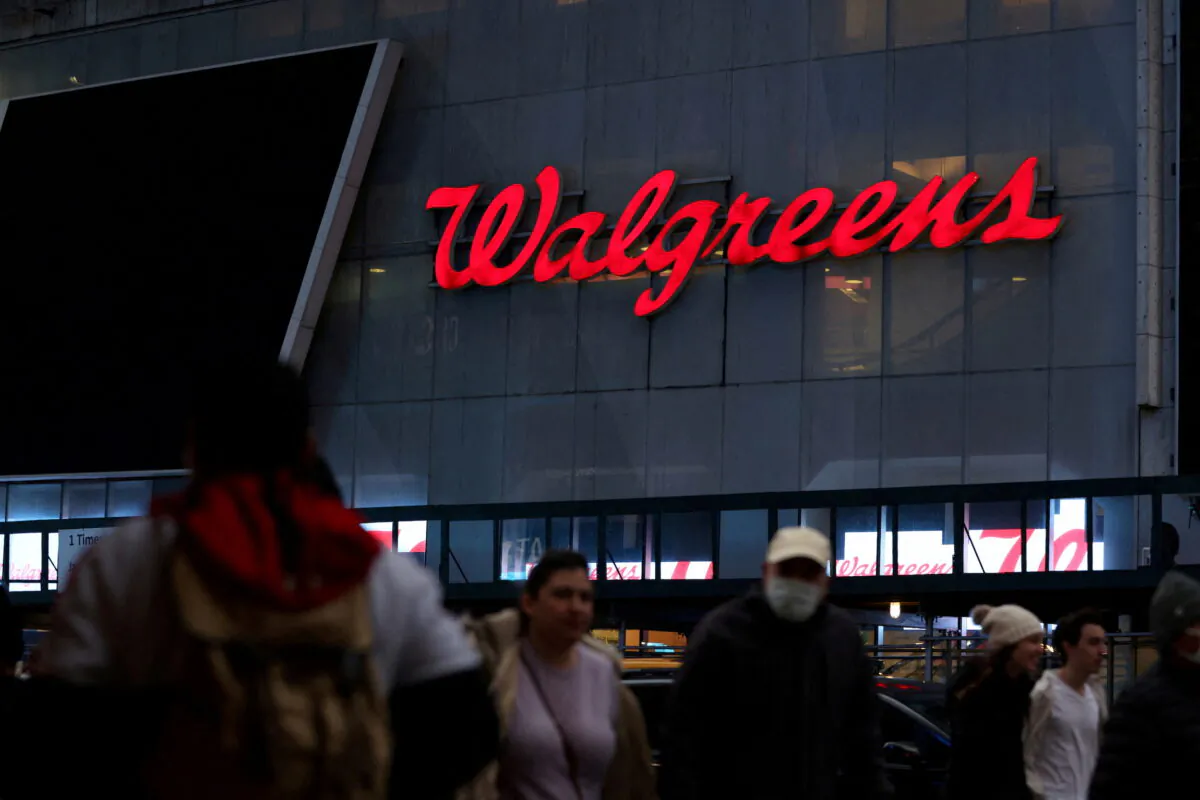 People walk by a Walgreens, owned by the Walgreens Boots Alliance Inc., in Manhattan, New York., on Nov. 26, 2021. (Andrew Kelly/Reuters)