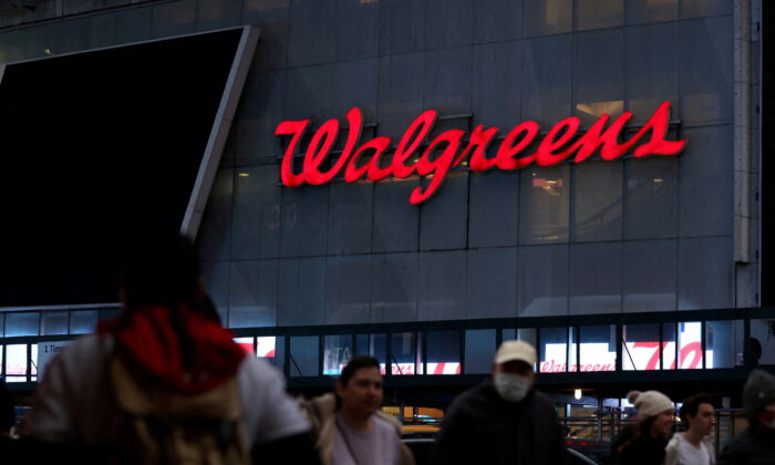 People walk by a Walgreens, owned by the Walgreens Boots Alliance Inc., in Manhattan, New York on Nov. 26, 2021. (Andrew Kelly/Reuters)