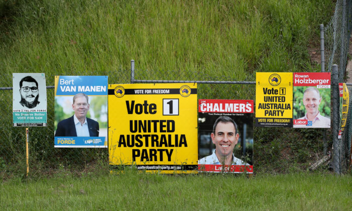 Federal election campaign posters are seen in Kingston, south of Brisbane, Australia, on April 22, 2022. (AAP Image/Jono Searle)