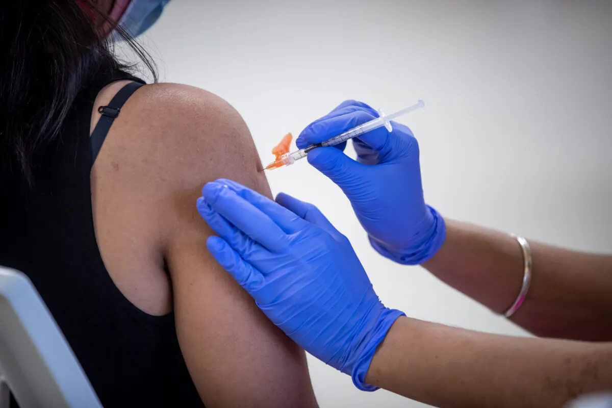 A woman receives a COVID-19 vaccine at a clinic in Surrey, B.C., on May 14, 2021. (The Canadian Press/Darryl Dyck)