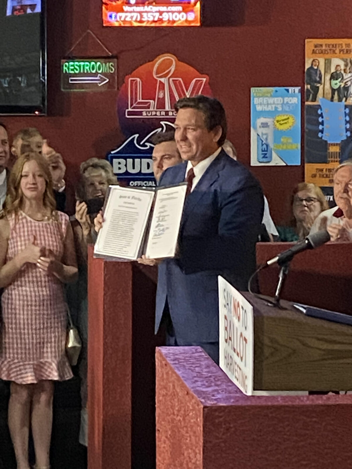 Florida Governor Ron DeSantis displays the newly signed election integrity law that creates the nation's first office to investigate election fraud at an April 25, 2022 press conference in Spring Hill, Florida. 