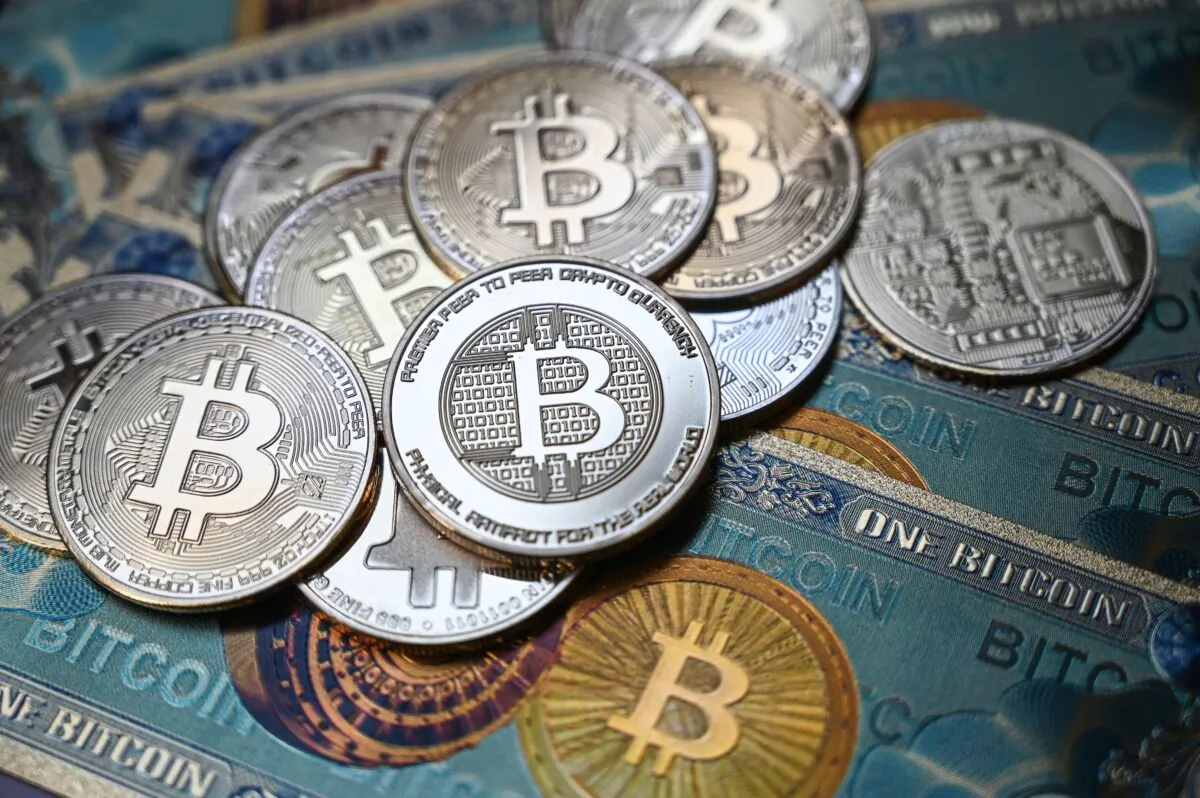 This illustration photograph, which is taken in Istanbul, Turkey on July 19, 2021, shows a physical banknote and coin imitations of the Bitcoin crypto currency. (Ozan Kose/AFP via Getty Images)