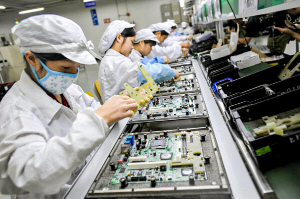 Chinese workers are assembling electronic components at the factory of Taiwanese technology giant Foxconn in Shenzhen, China.