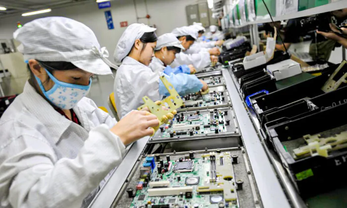 Chinese workers assemble electronic components at the Taiwanese technology giant Foxconn's factory in Shenzhen City, Guangdong Province, China, on May 26, 2010. (AFP/AFP/Getty Images)