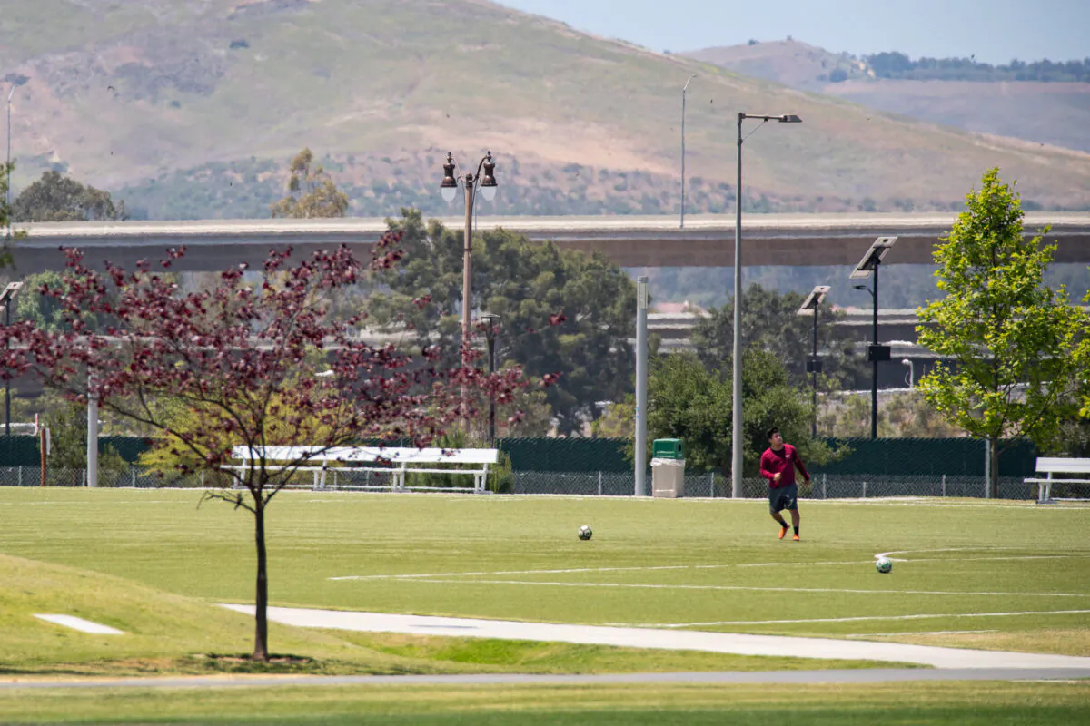 A man plays soccer at the Great Park in Irvine, Calif., on May 6, 2021. (John Fredricks/The Epoch Times)
