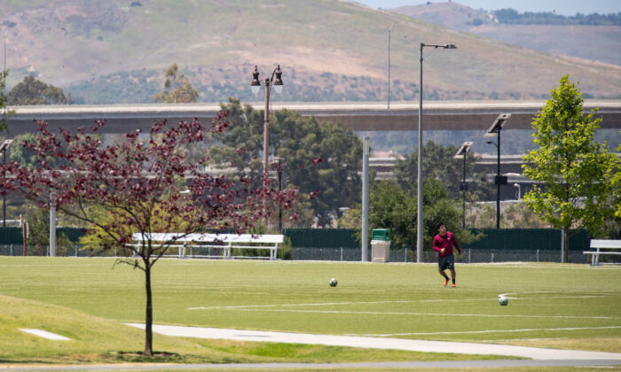 A man plays soccer at the Orange County Great Park in Irvine, Calif., on May 6, 2021. (John Fredricks/The Epoch Times)