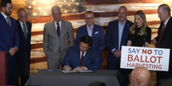 At an April 25, 2022 press conference in Spring Hill, Florida, Florida Governor Ron DeSantis signs bill into law that establishes the nation's first office to investigate voter fraud.