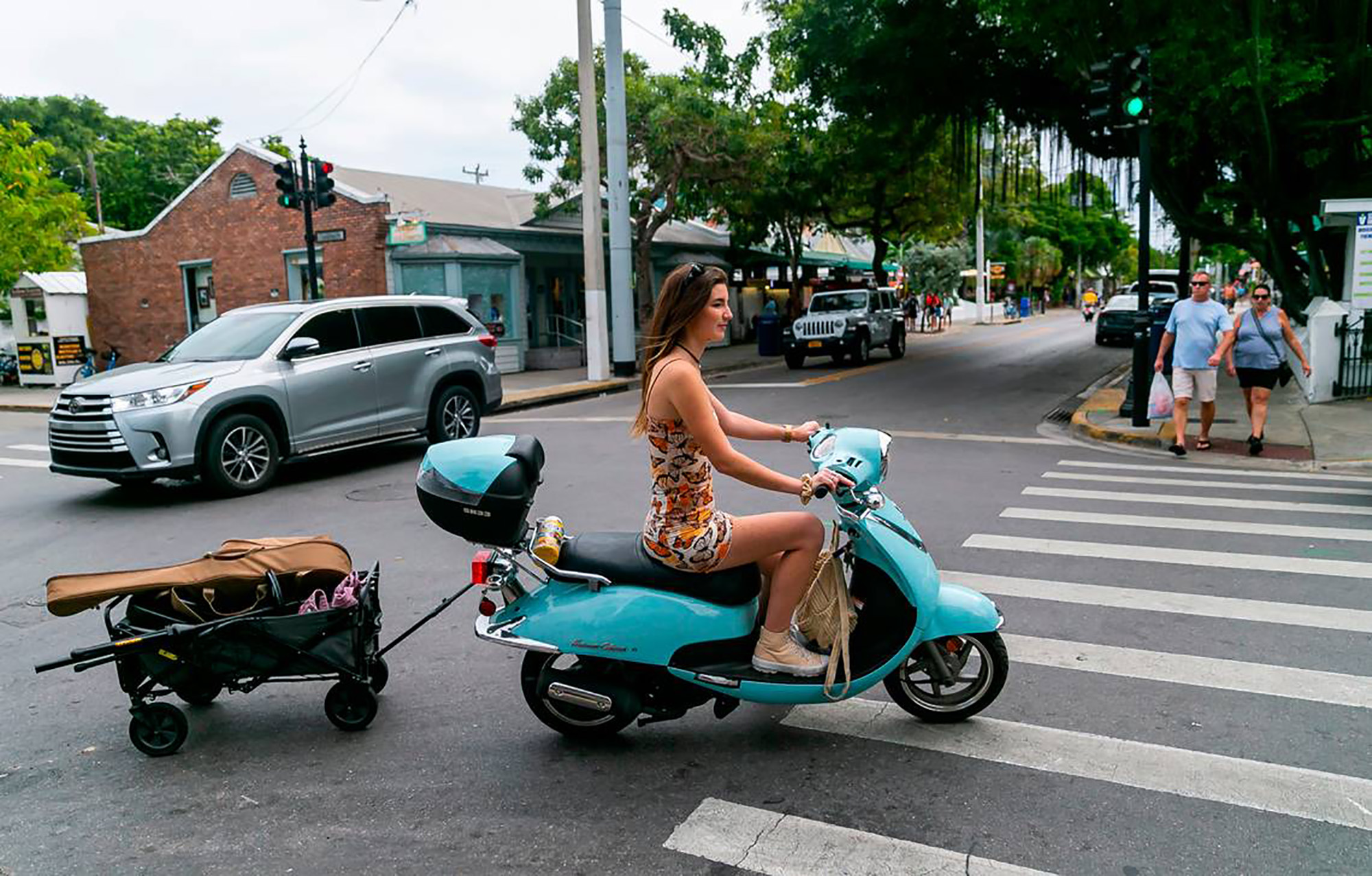 Singer Elle Haley rides a scooter with her music equipment in Key West, Florida