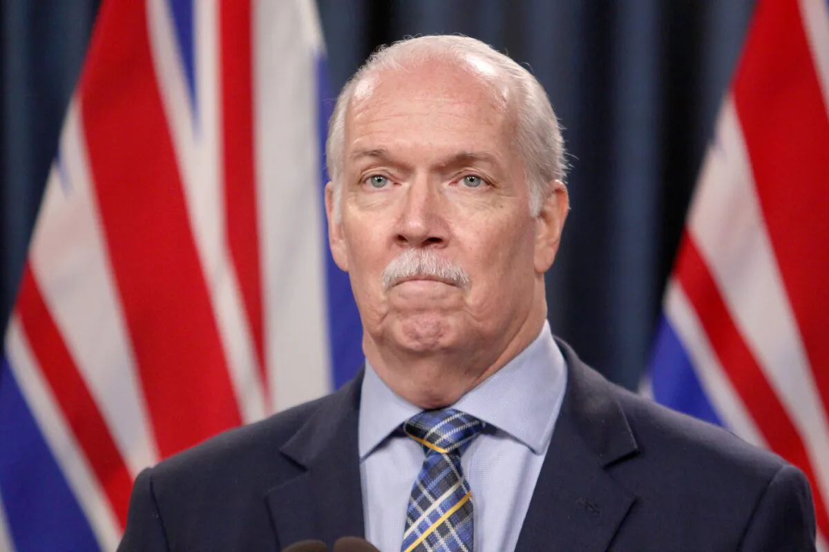 Premier John Horgan answers questions during a news conference in the press theatre at the legislature in Victoria, March 11, 2022. (Chad Hipolito/The Canadian Press)