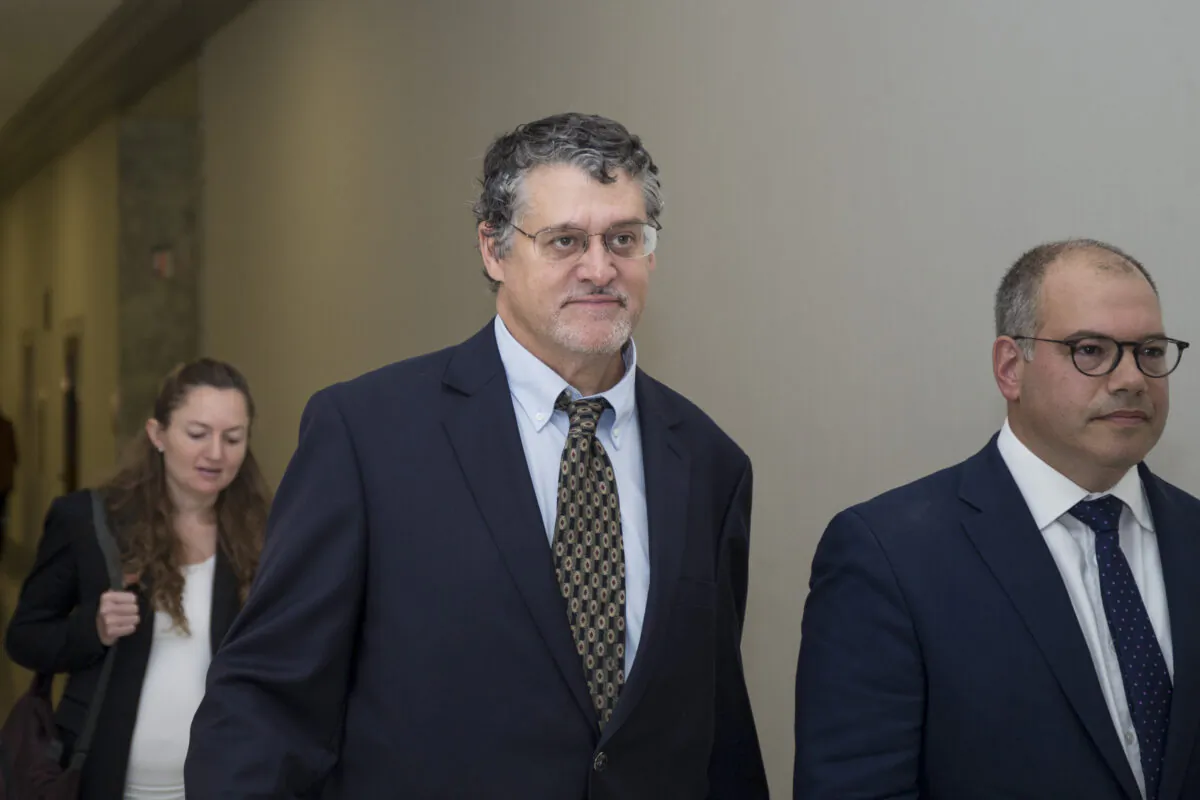 Fusion GPS co-founder Glenn Simpson (C) leaves with his attorney, Joshua Levy (R) after meeting with members of the House Judiciary and Oversight Committee in Washington on Oct. 16, 2018. (Zach Gibson/Getty Images)