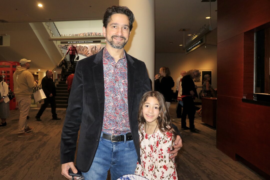 Omar Mohammed and his daughter at the Shen Yun Performing Arts matinee performance at Northern Alberta Jubilee Auditorium, in Edmonton, on April 24, 2022. (Sunny Chen/The Epoch Times)