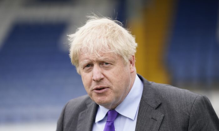 UK Prime Minister Boris Johnson during a visit to Bury FC at their Gigg Lane ground, in Bury, Greater Manchester, England, on April 25, 2002. (Danny Lawson - WPA Pool/Getty Images)