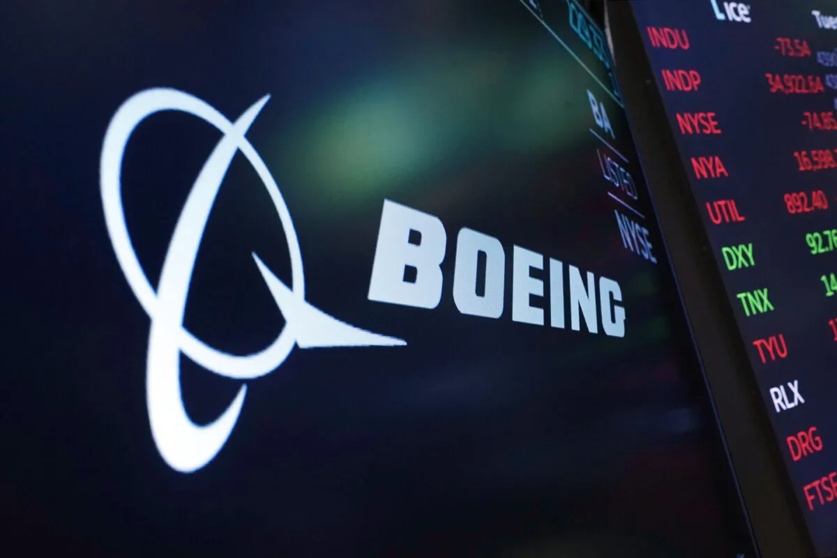 The logo for Boeing appears on a screen above a trading post on the floor of the New York Stock Exchange on July 13, 2021.  (Richard Drew/AP Photo)