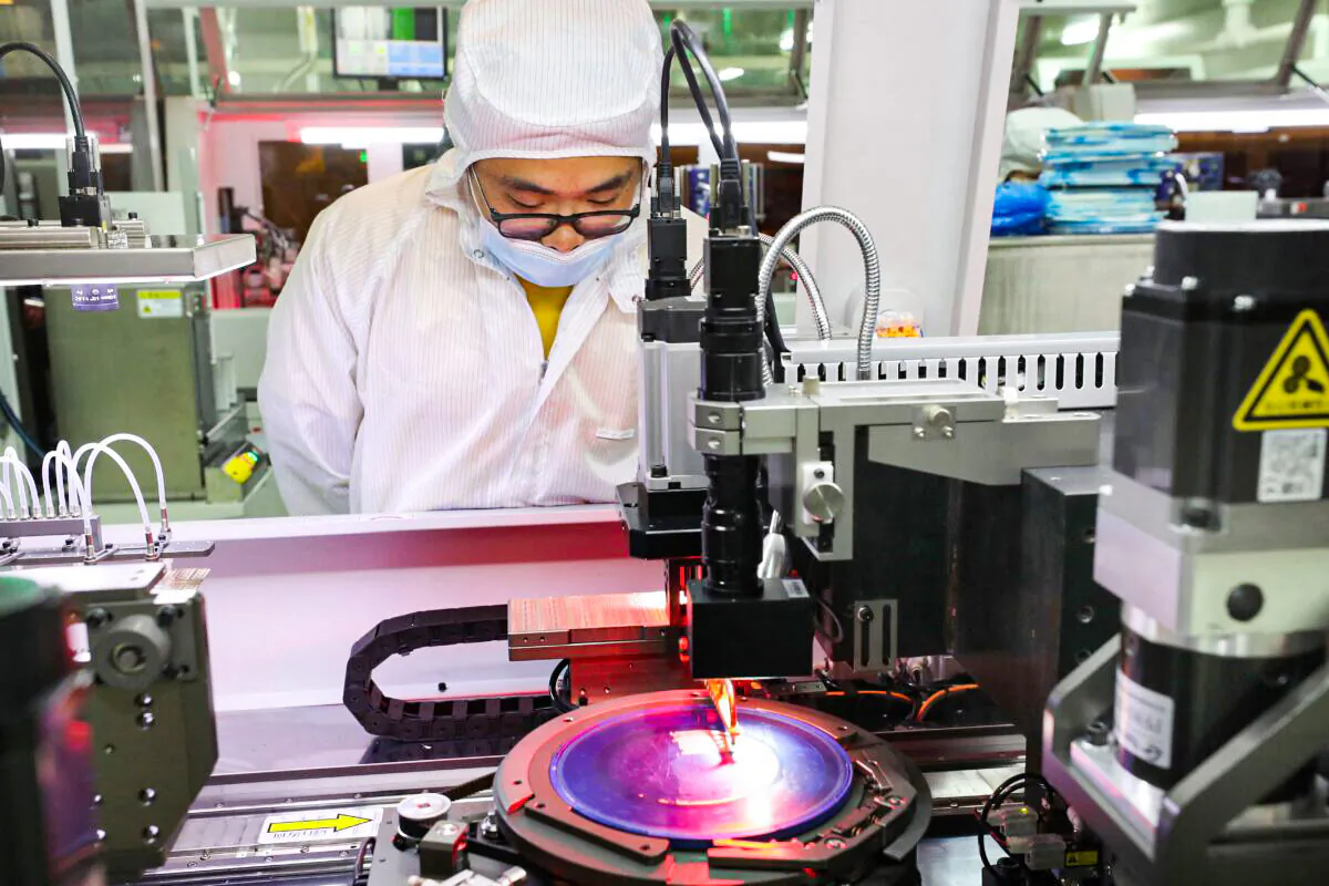 An employee makes semiconductor chips at the Jiejie Microelectronics Co.   factory in Nantong, China on March 17, 2021. (STR/AFP via Getty Images)