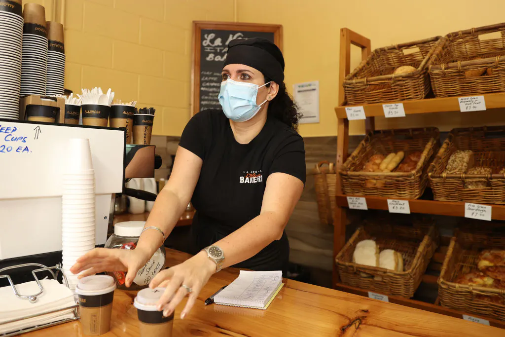A woman serves coffee at La Nonna Italian Bakery in Kaiwaka, Northland in Auckland, New Zealand, on Sept. 8, 2021. (Fiona Goodall/Getty Images)