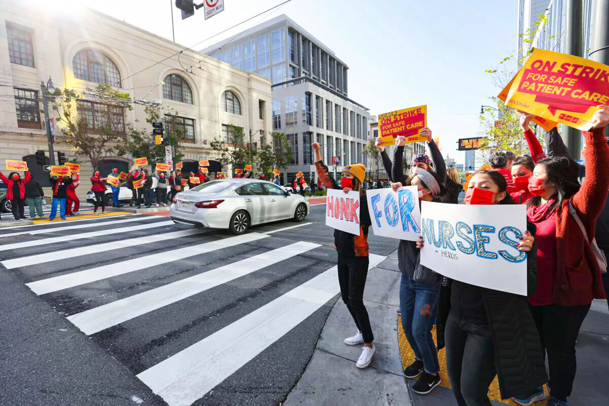 Sutter Health nurses and health care workers hold signs as they participate in a one day strike outside of the California Pacific Medical Center Van Ness Campus in San Francisco, California, on April 18, 2022. (Justin Sullivan/Getty Images)