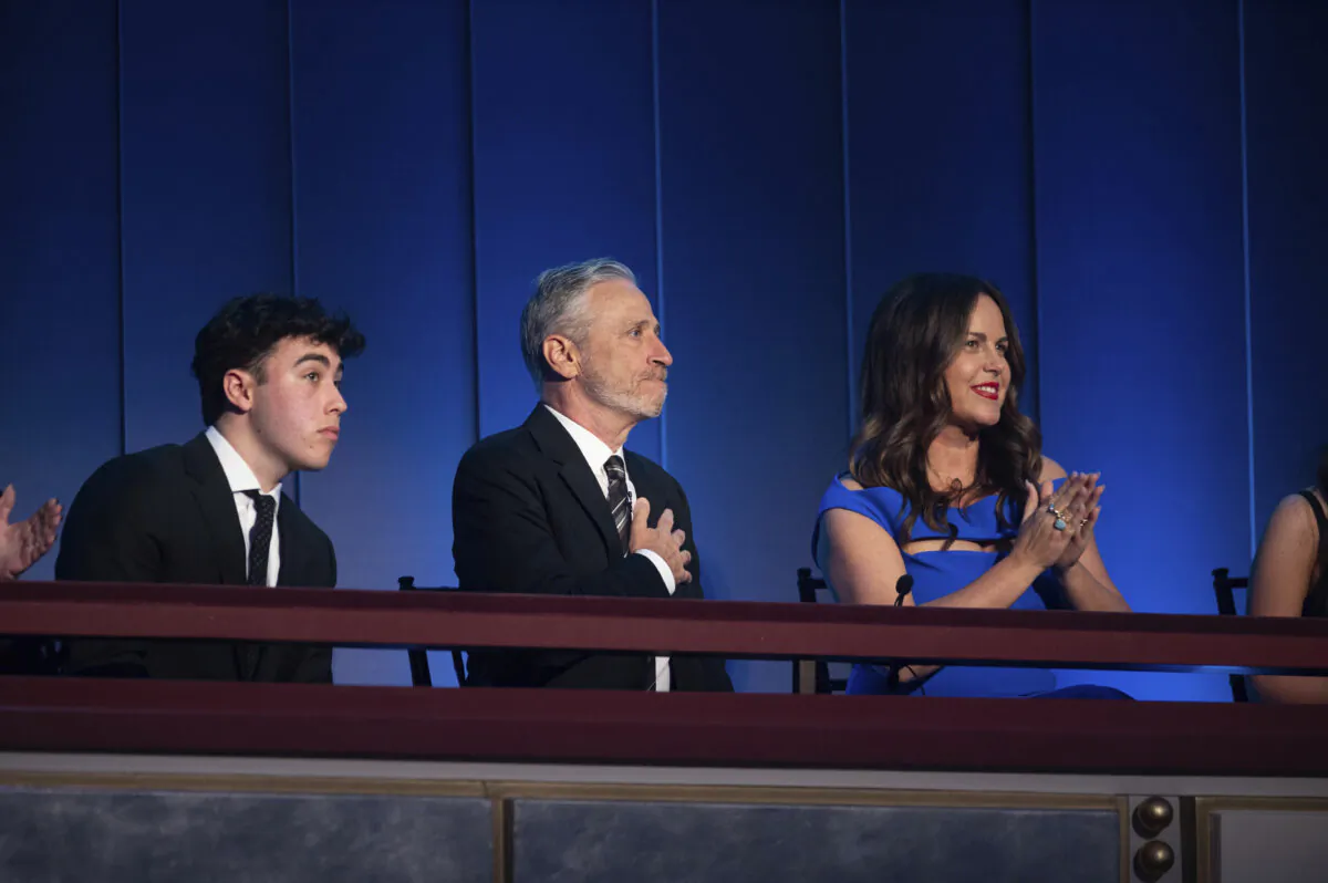 Mark Twain Prize recipient Jon Stewart (C) is joined by his wife Tracey Stewart (R), and son Nate Stewart (L) after being introduced at the start of the 23rd annual Mark Twain Prize for American Humor at the Kennedy Center for the Performing Arts in Washington on April 24, 2022. (Kevin Wolf/AP Photo)