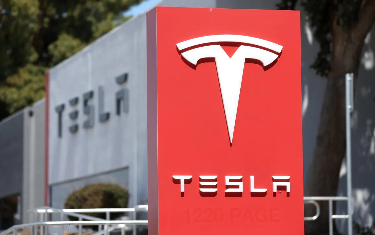 A sign is posted in front of a Tesla service center in Fremont, Calif., on April 20, 2022. (Justin Sullivan/Getty Images)