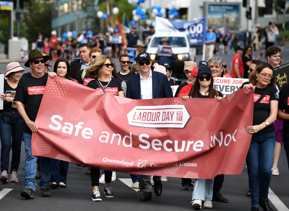 Federal Opposition Leader Anthony Albanese (centre) and ACTU President Michele O'Neil (4th left) take part in the 2021 Labour Day March in Brisbane, Australia, on May 3, 2021. (Dan Peled/AAP Image)