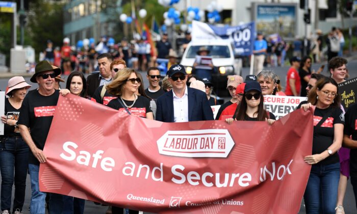 Federal Opposition Leader Anthony Albanese (centre) and ACTU President Michele O'Neil (4th left) take part in the 2021 Labour Day March in Brisbane, Australia, on May 3, 2021. (Dan Peled/AAP Image)