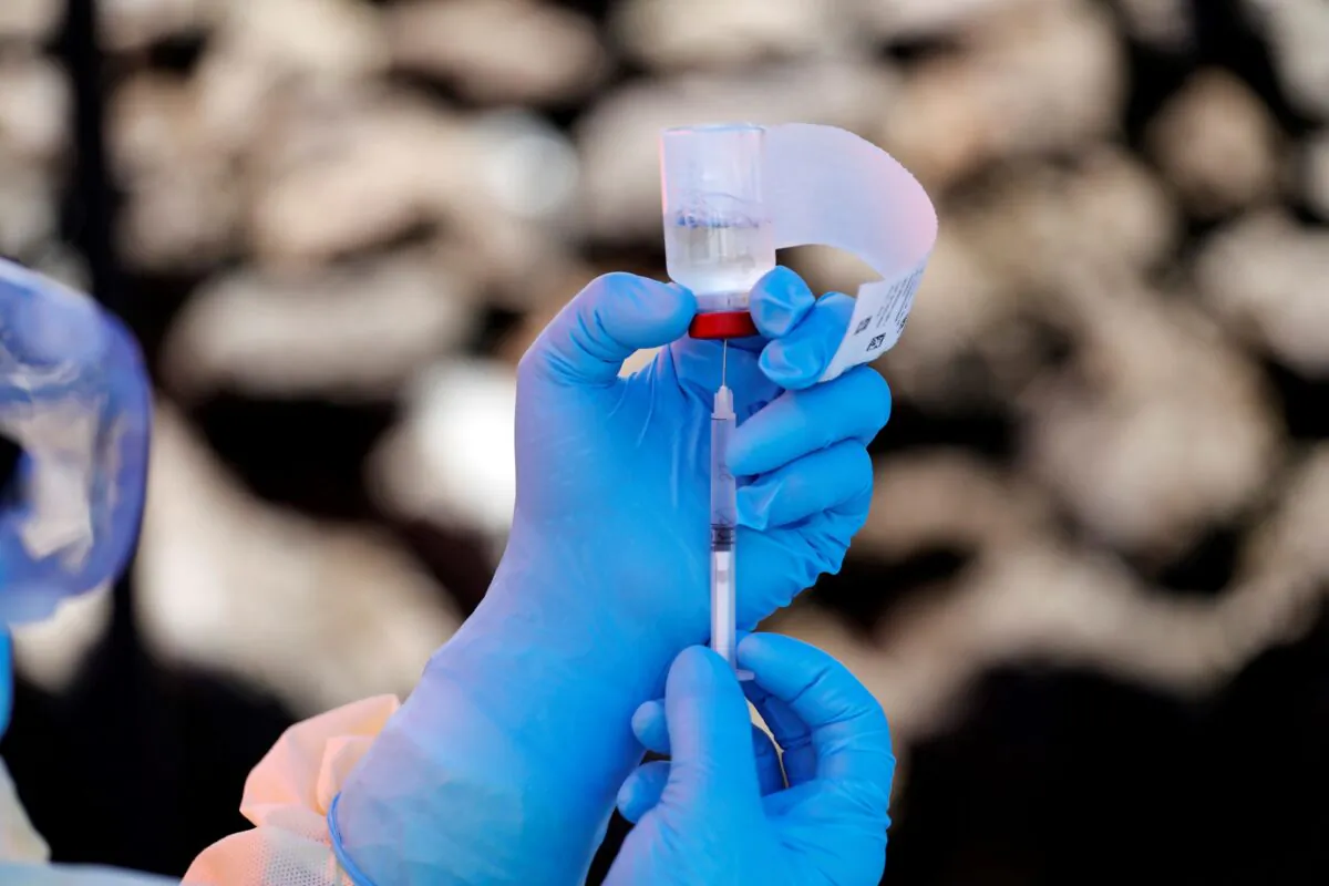 A health worker fills a syringe with Ebola vaccine before injecting it to a patient, in Goma, Democratic Republic of Congo, on Aug. 5, 2019. (Baz Ratner/Reuters)