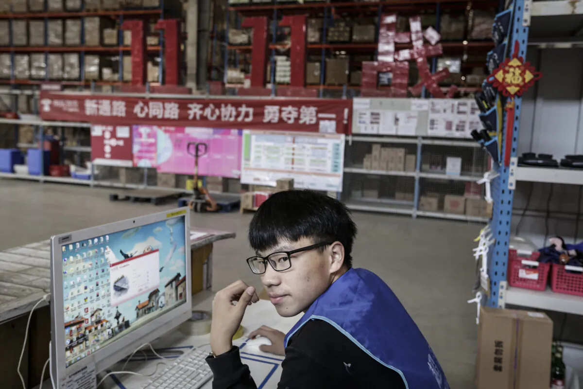 An employee uses a computer to check parcels at the warehouse of a logistics base of JingDong Group on November 5, 2019 in Wuhan, Hubei Province.China. (Wang He/Getty Images)