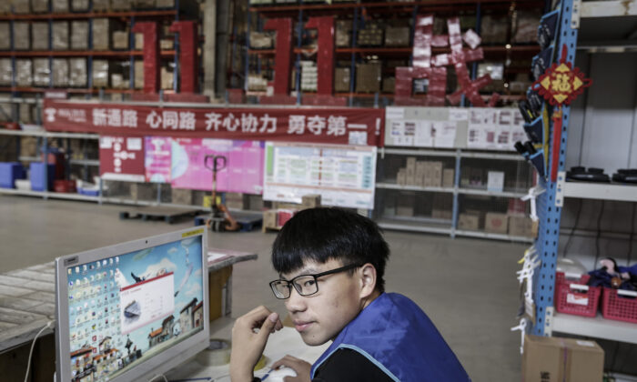 An employee uses a computer to check parcels at the warehouse of a logistics base of JingDong Group on November 5, 2019 in Wuhan, Hubei Province.China. (Wang He/Getty Images)
