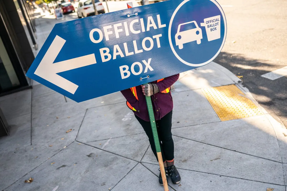 An election worker directs voters to a ballot drop off location in Portland, Ore., on Nov. 2, 2020. (Nathan Howard/Getty Images)