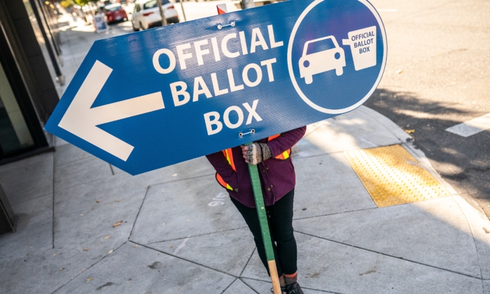 An election worker directs voters to a ballot drop off location in Portland, Oregon, on Nov. 2, 2020. (Nathan Howard/Getty Images)