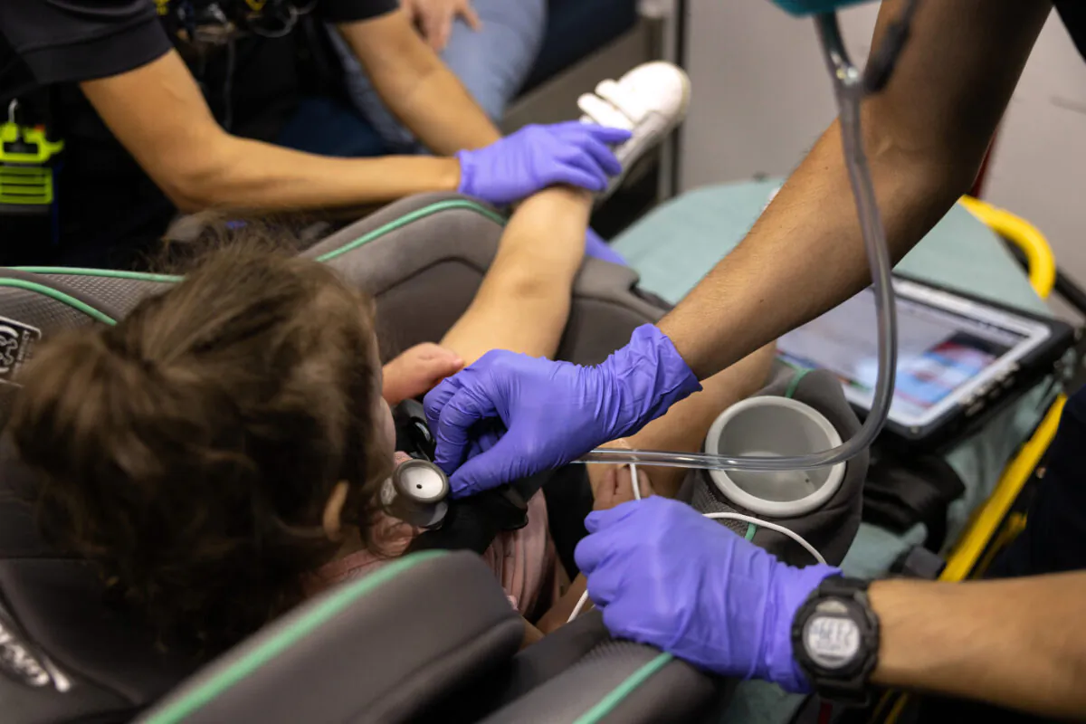 A medic prepares to transfer a young girl to a hospital in Houston, on Aug. 25, 2021. (John Moore/Getty Images)