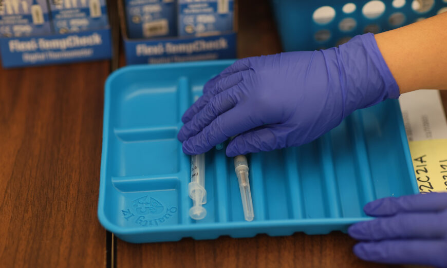 A healthcare worker prepares COVID-19 vaccines at a clinic in Florida on May 20, 2021. (Joe Raedle/Getty Images)