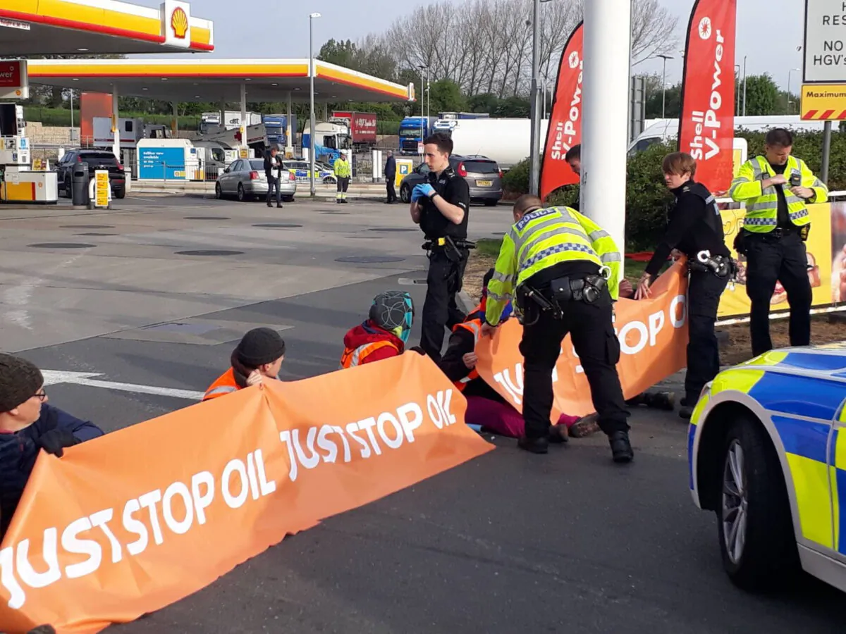 Handout photo issued by Just Stop Oil of campaigners staging a protest in the Shell petrol garage at the Cobham Services on the M25 in Cobham, Surrey, on April 28, 2022. (PA Media)