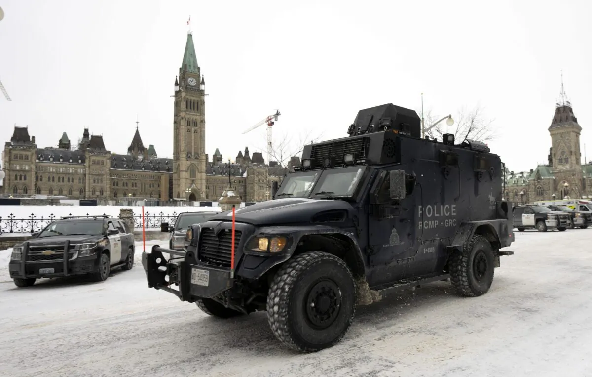 An RCMP tactical vehicle drives past the Parliament Buildings days after a massive police operation quelled the Freedom Convoy protest, in Ottawa on Feb. 20, 2022. (Adrian Wyld/The Canadian Press)