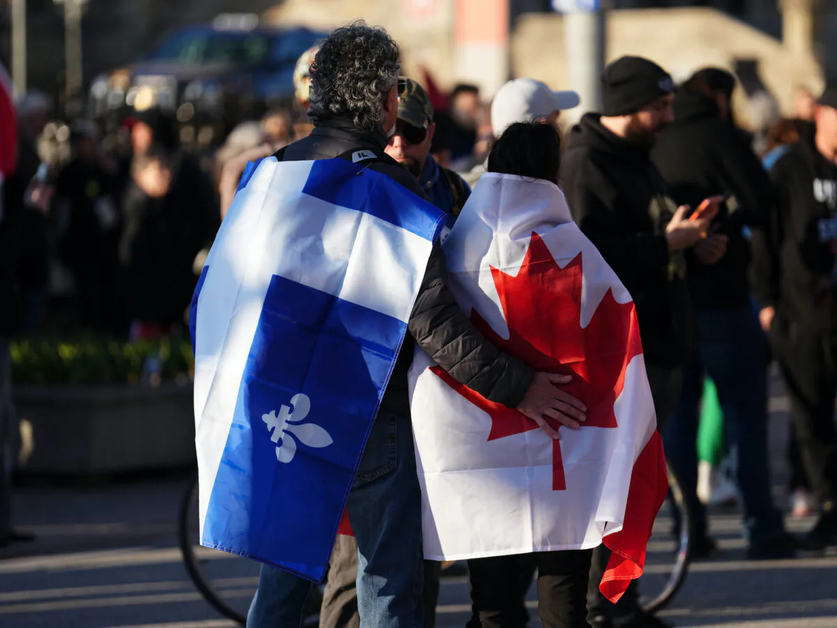 Protesters wearing Quebec and Canadian flags attend a demonstration in Ottawa on April 29, 2022. (The Canadian Press/Sean Kilpatrick)