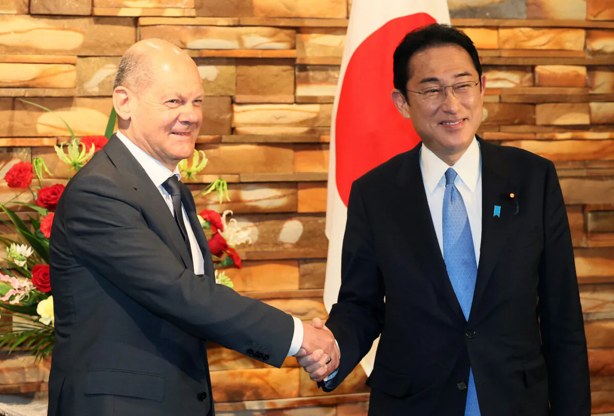 German Chancellor Olaf Scholz and Japanese Prime Minister Fumio Kishida shake hands before their bilateral summit in Tokyo, Japan on April 28, 2022. (Yoshikazu Tsuno/Getty Images)