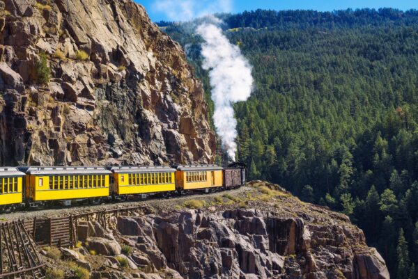 Historic steam engine train travels through the San Juan Mountains in Colorado.
