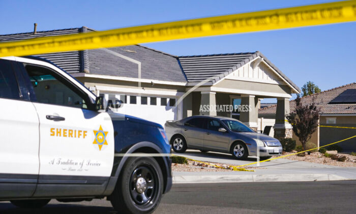 Los Angeles County Sheriff deputies guard a home in the city of Lancaster in the high desert Antelope Valley north of Los Angeles on Nov. 29, 2021. (Ringo H.W. Chiu/AP Photo)