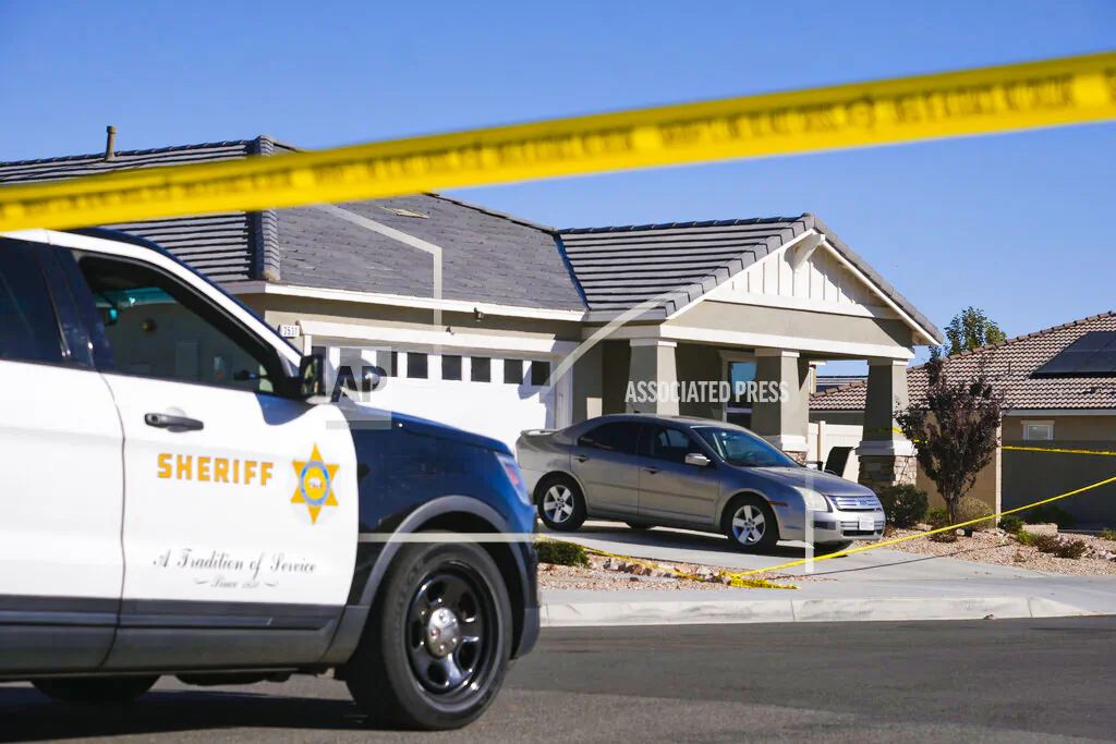 Los Angeles County Sheriff deputies guard a home in the city of Lancaster in the high desert Antelope Valley north of Los Angeles on Nov. 29, 2021. (Ringo H.W. Chiu/AP Photo)
