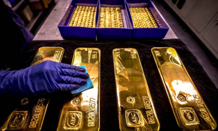 A worker polishes gold bullion bars at the ABC Refinery in Sydney on Aug. 5, 2020. (David Gray/AFP via Getty Images)