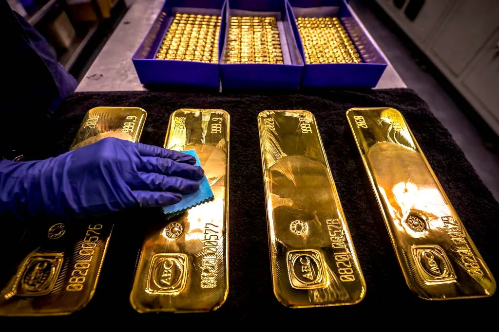 A worker polishes gold bullion bars at the ABC Refinery in Sydney on Aug. 5, 2020. (David Gray/AFP via Getty Images)