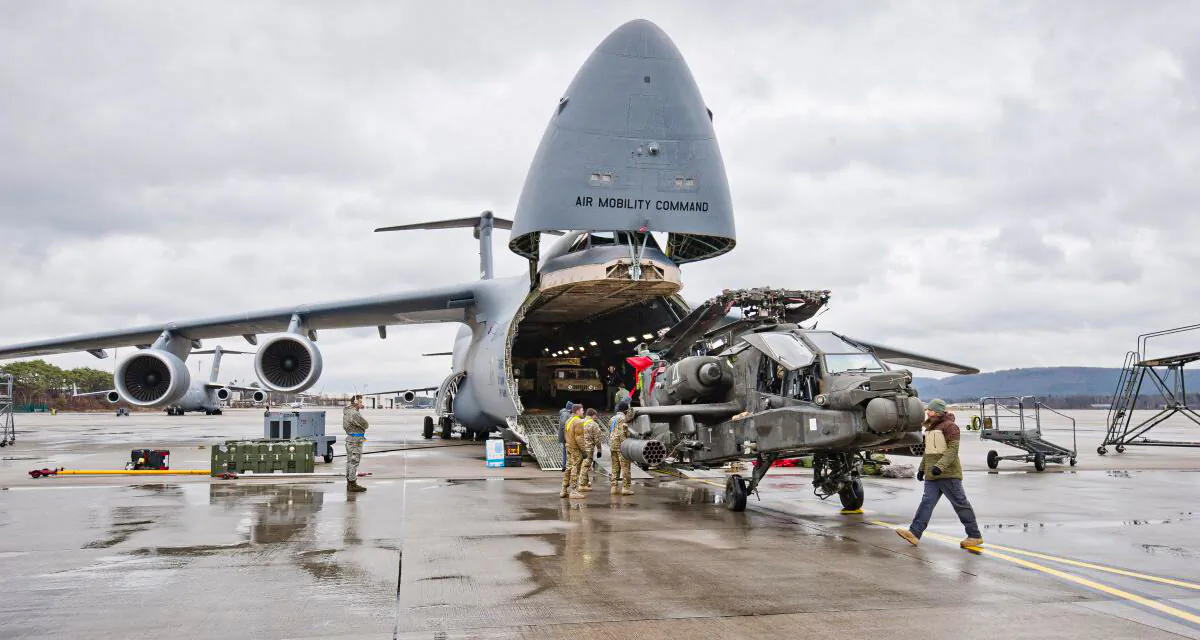 An Apache attack helicopter is being unloaded from a Galaxy C-5 transport plane at the US Air Base in Ramstein, western Germany, on Feb. 22, 2017. The first attack helicopters of the US Army, intended to be deployed during military exercises with NATO partners for the operation "Atlantic Resolve", arrived for a stopover in Ramstein. (MARTIN GOLDHAHN/AFP/Getty Images)