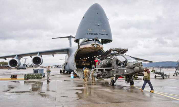 An Apache attack helicopter is being unloaded from a Galaxy C-5 transport plane at the US Air Base in Ramstein, western Germany, on Feb. 22, 2017. The first attack helicopters of the US Army, intended to be deployed during military exercises with NATO partners for the operation "Atlantic Resolve", arrived for a stopover in Ramstein. (MARTIN GOLDHAHN/AFP/Getty Images)