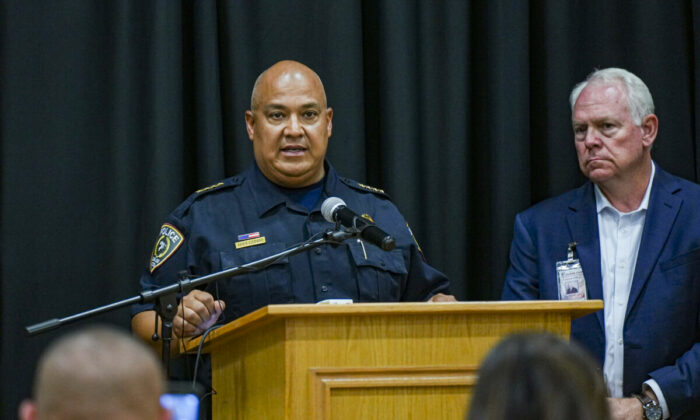 Pete Arredondo, chief of police for the Uvalde Consolidated Independent School District (L), speaks at a press conference while Superintendent Hal Harrell looks on, following a mass school shooting in Uvalde, Texas, on May 24, 2022. (Charlotte Cuthbertson/The Epoch Times)
