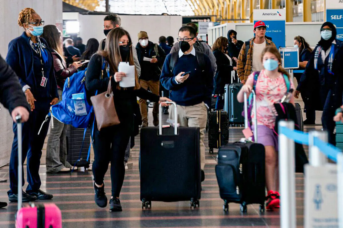 Travelers walk through Ronald Reagan Washington National Airport in Arlington, Va., on April 19, 2022. (Stefani Reynolds/AFP via Getty Images)