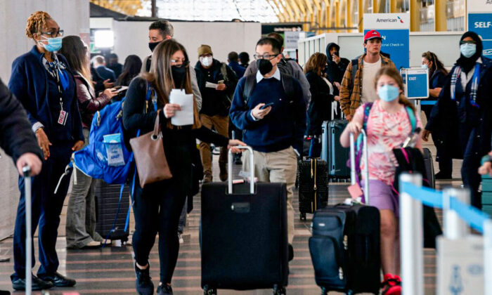 Travelers walk through Ronald Reagan Washington National Airport in Arlington, Va., on April 19, 2022. (Stefani Reynolds/AFP via Getty Images)