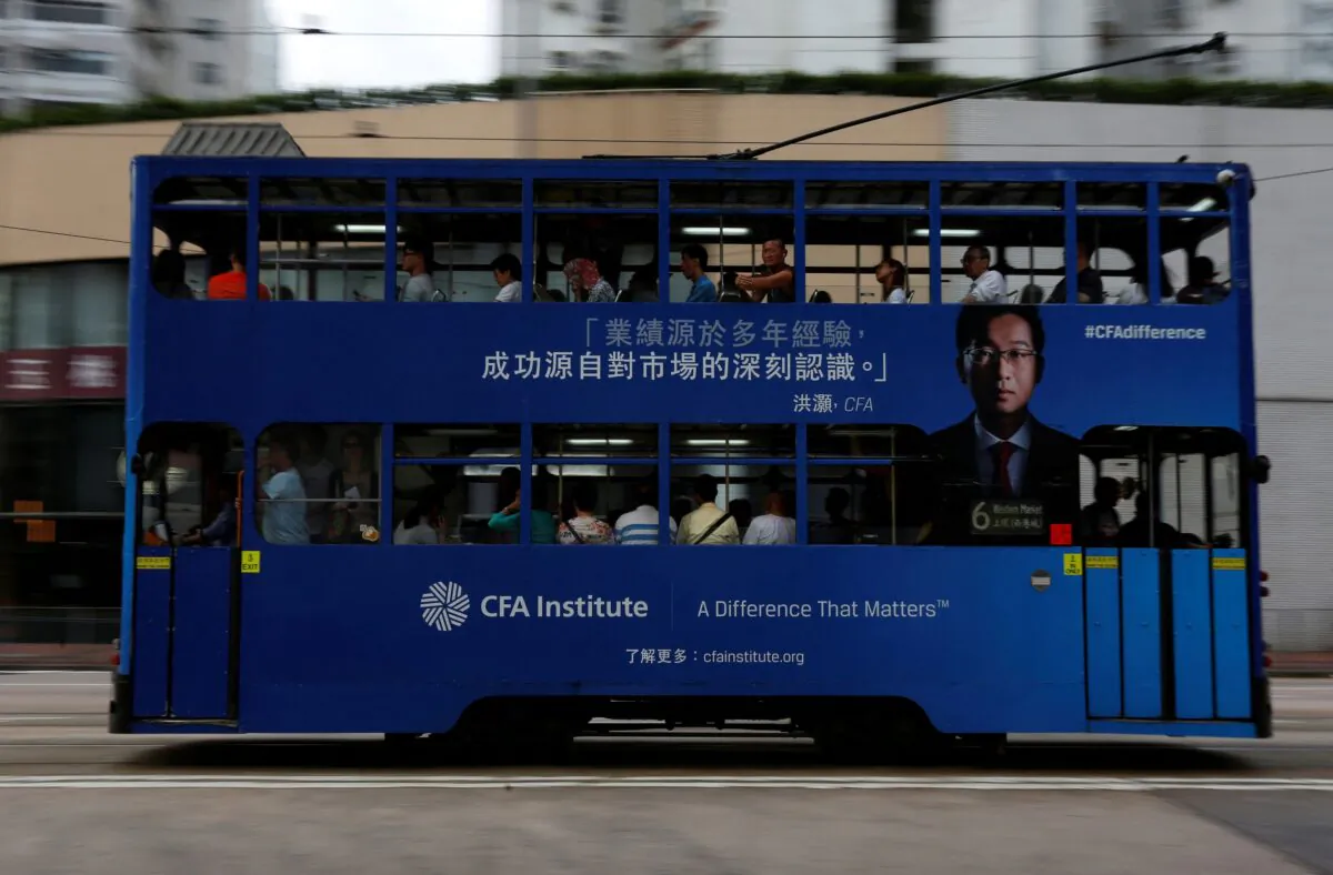 A bus with an advertisement for CFA Institute, featuring Hong Hao, head of research at Bocom International, in Hong Kong, on Oct. 6, 2016. (Bobby Yip/Reuters)