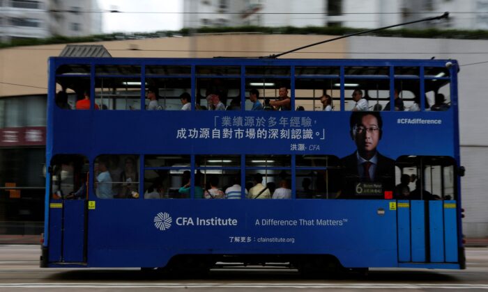 A bus with an advertisement for CFA Institute, featuring Hong Hao, head of research at Bocom International, in Hong Kong, on Oct. 6, 2016. (Bobby Yip/Reuters)