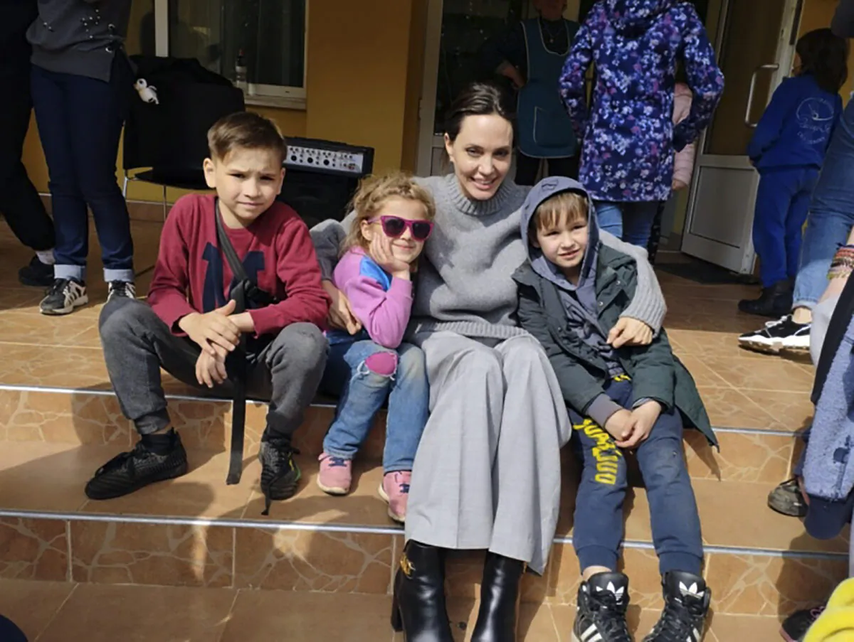 Angelina Jolie, Hollywood movie star and UNHCR goodwill ambassador, poses for photo with children in Lviv, Ukraine, on Apr. 30, 2022. (Maksym Kozutsky/Lviv City Hall via AP)