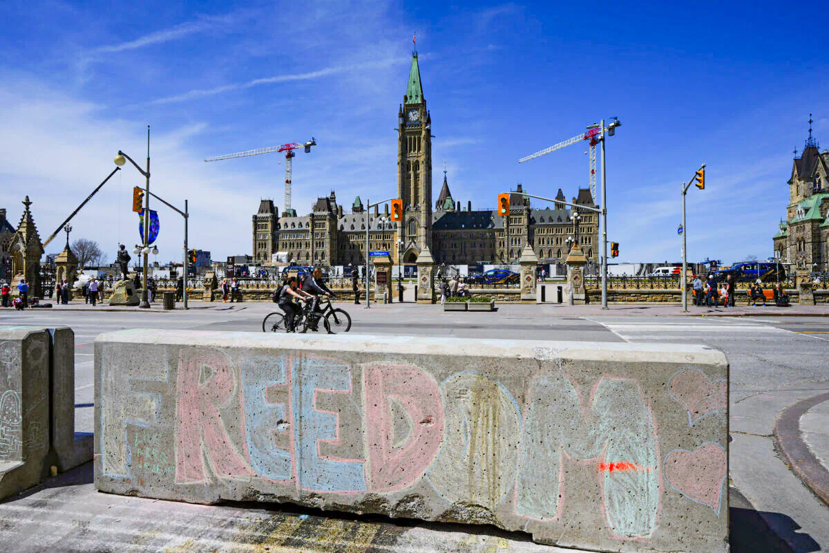 Chalk art asking for freedom is seen across the street from Parliament Hill in downtown Ottawa on May 1, 2022. (Sean Kilpatrick/The Canadian Press)